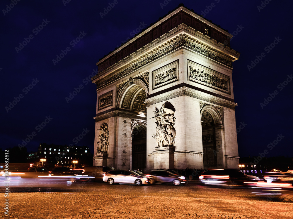 View of famous Arc de Triomphe at night in Paris, France