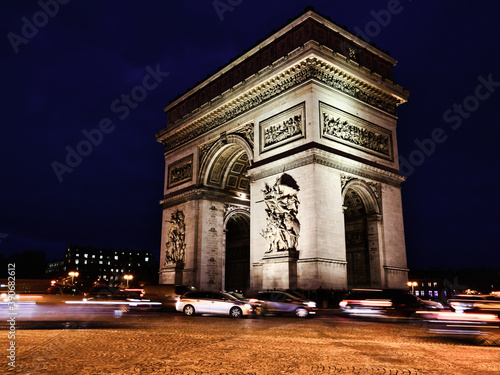 View of famous Arc de Triomphe at night in Paris, France © Mummert-und-Ibold