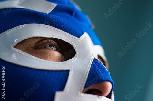 Close up of blue eyed man wearing  a blue wrestling mask photo