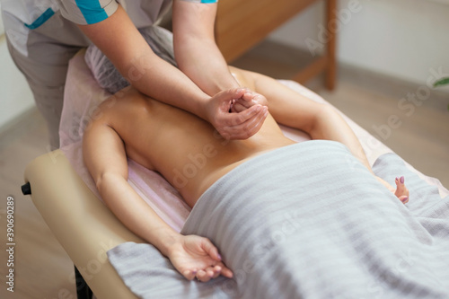Caucasian woman getting a spine massage in the spa salon. Body care concept.