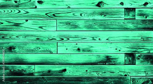 Rough vintage colorful green teal reclaimed wood surface with aged plank boards lined up. Wooden planks on a wall or floor with grain and texture. 