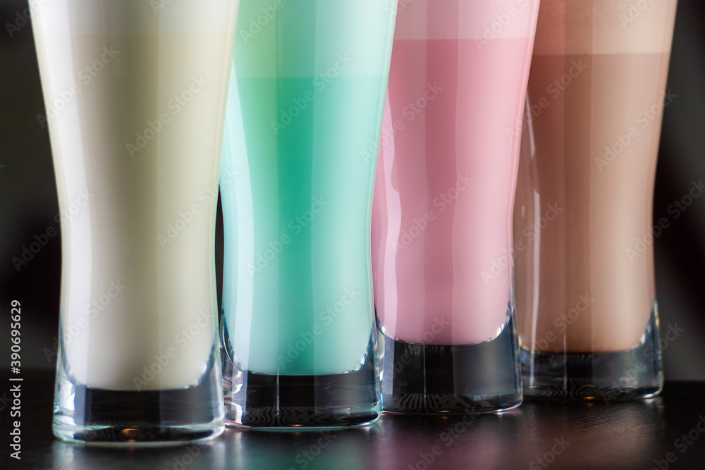 Colored milkshakes in tall glass glasses