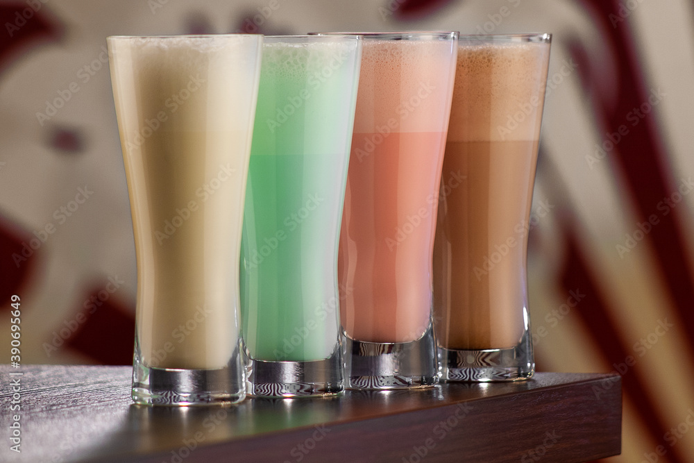 Colored milkshakes in tall glass glasses