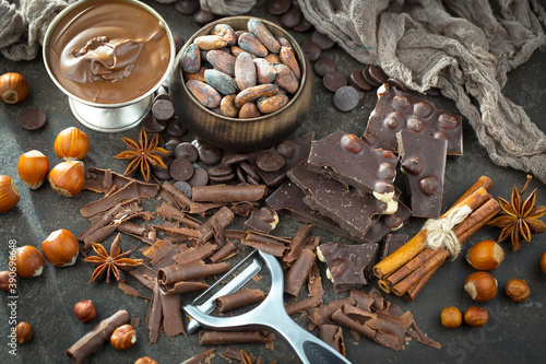Fototapeta Naklejka Na Ścianę i Meble -  Dark chocolate on a background of cocoa fruits and kitchen accessories