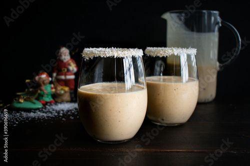 Glasses of Coquito Rimmed with Coconut Flakes: Traditional Puerto Rican Christmas drink with coconut, rum, and cinnamon photo