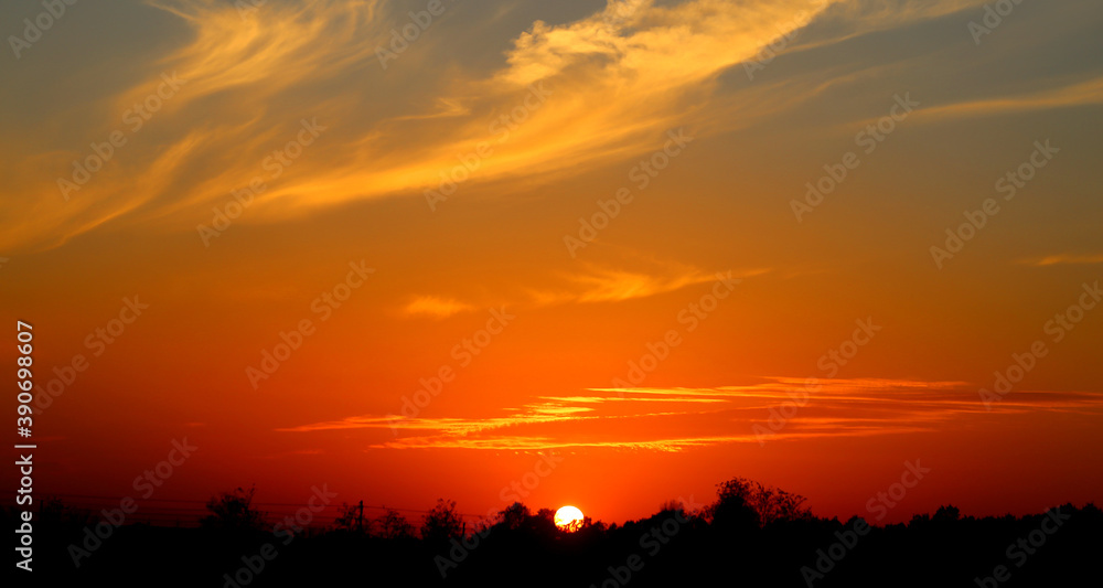 Photo of a beautiful sunset landscape over a field