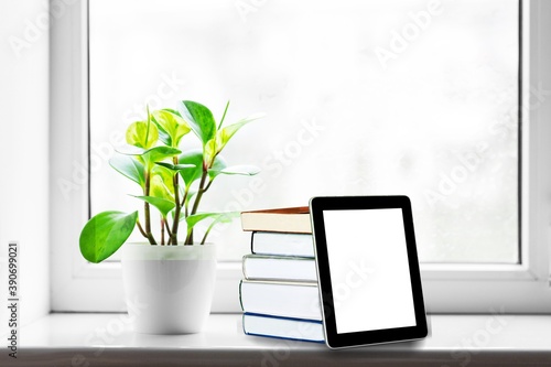 Fototapeta Naklejka Na Ścianę i Meble -  Stack of books with modern digital tablet on table