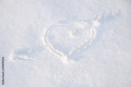 One heart in the snow. A heart is drawn on the snow close-up. The shape of heart on the snow. Winter background.. © borislav15