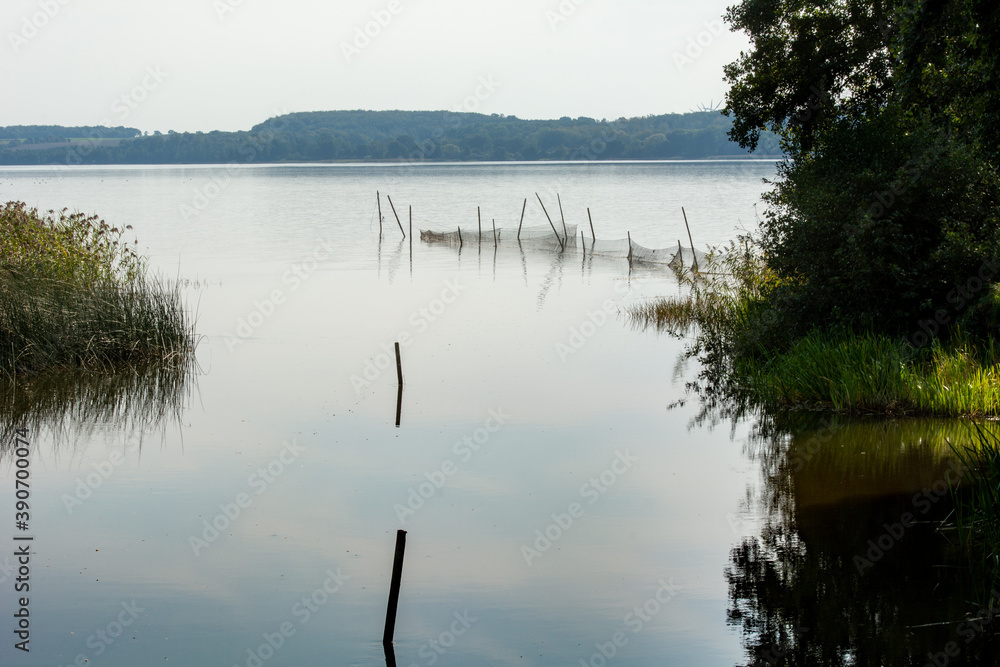 Obraz premium Beautiful scenery of a fishing net in a lake one of the latest days of summer. Picture from Ringsjon, Scania, Sweden. 