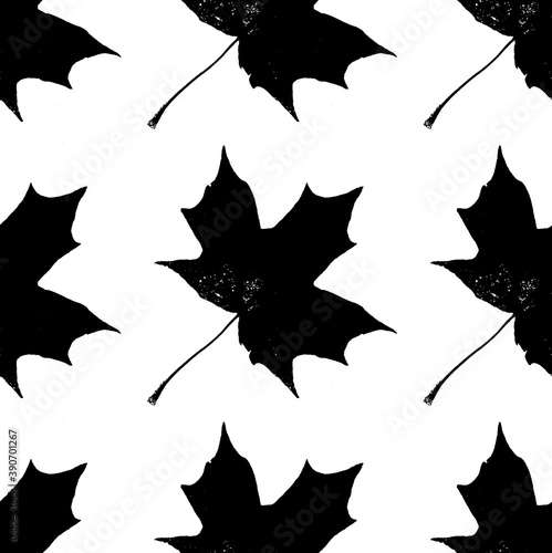 Seamless decorative pattern with a silhouettes of maple leaves