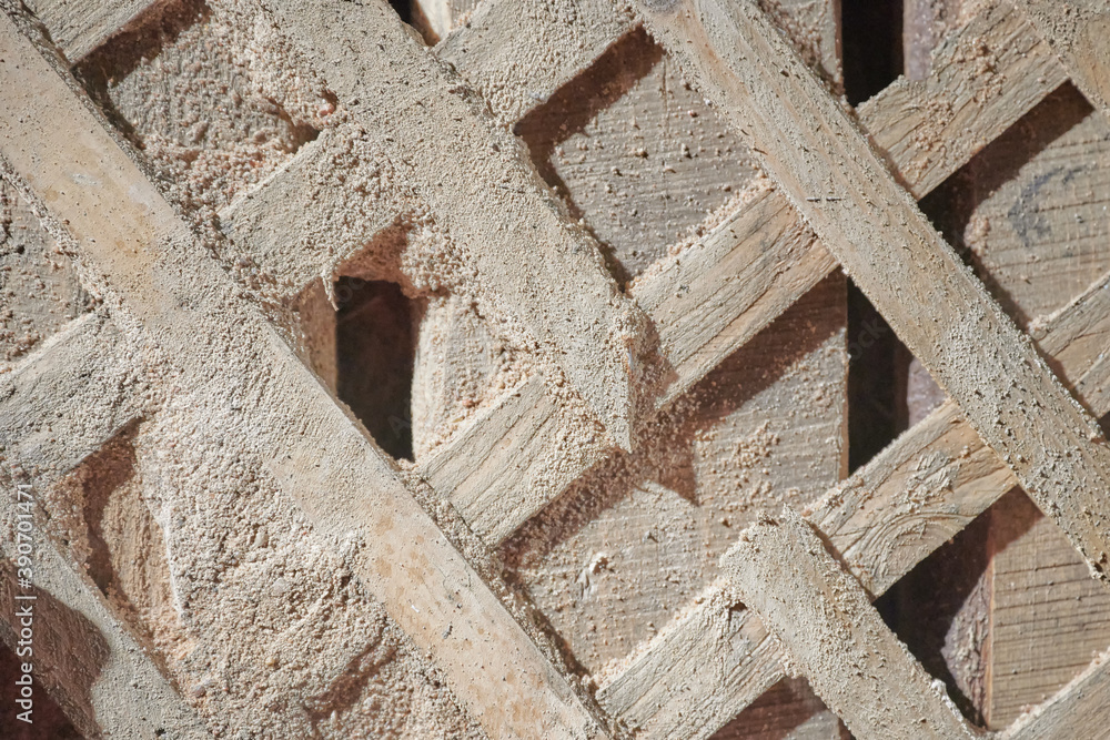 texture of the destroyed wall of a living room. Shingles nailed to the wall cross to cross for fixing the plaster. Photography - the concept of devastation and antiquity texture of the destroyed wall of a living room. Shingles nailed to the wall cross to cross for fixing the plaster. Photography - the concept of devastation and antiquity