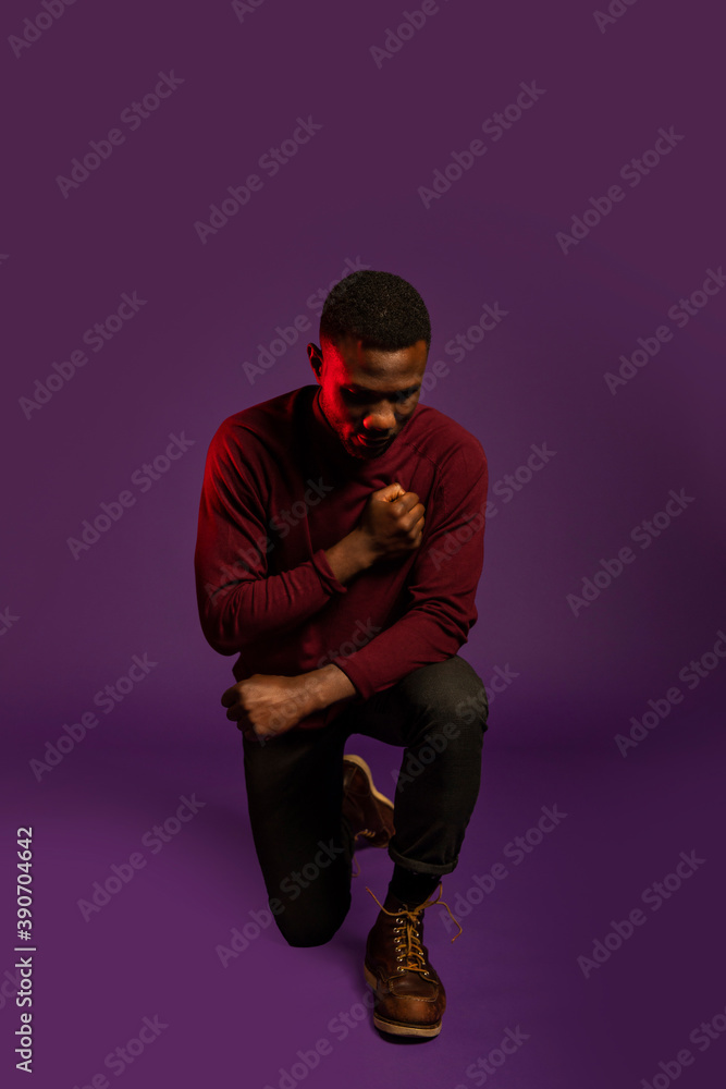 Black Man on Knee with Fist on Chest
