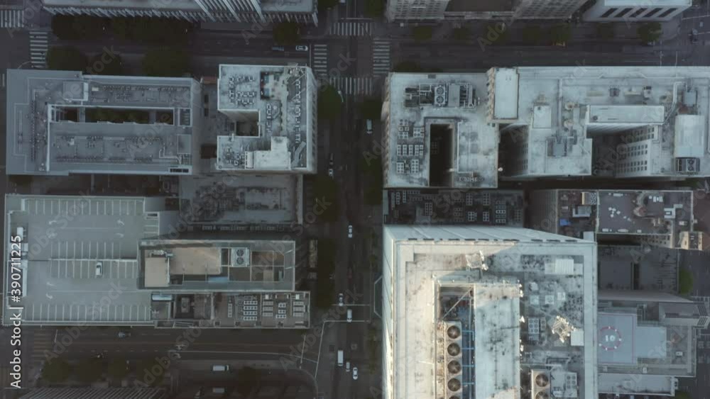 Establishing Shot of City from Aerial Birds Eye Top Down Overhead View perspective with White Rooftops and car traffic
