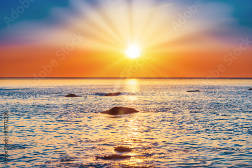 Photography Sunset sea with rocks and evening sunset sun on dramatic sky