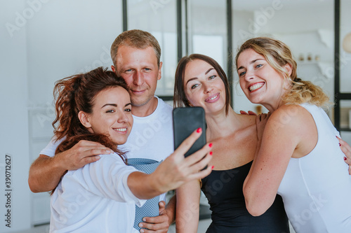 Smiling young people having fun making selfie photo