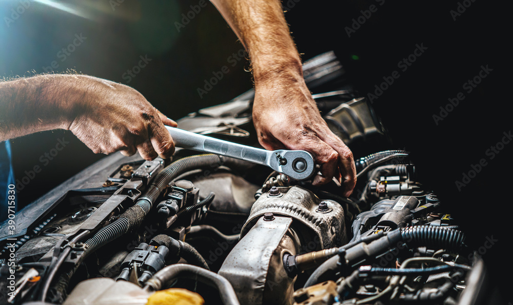 Obraz premium Auto mechanic working in garage. Repair service.