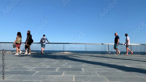 Time lapse footage of people walking by famous beach called 