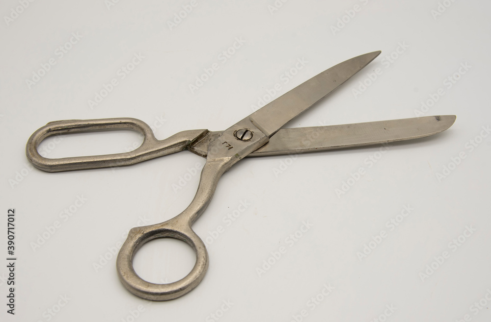 Old tailor scissors on a white background. Old tailor scissors on a white background.