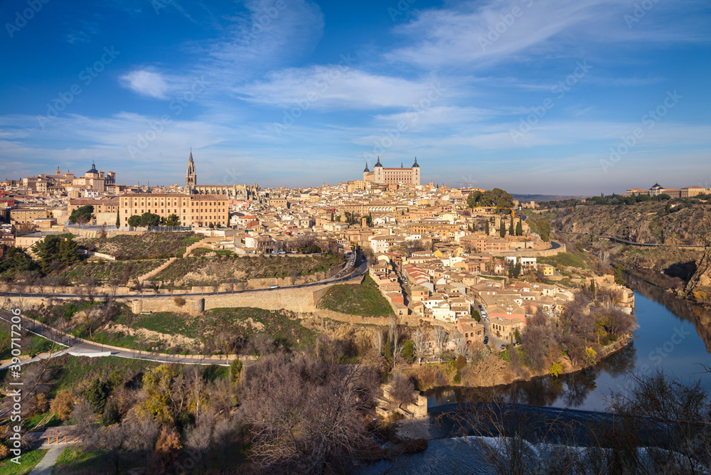 Beautiful view of Toledo city skyline with Cathedral, Alcazar and Tagus River with blue sky and clouds, Spain