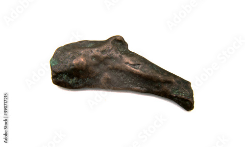 antique copper coin in the shape of a dolphin on a white background