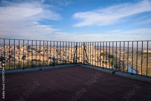 Panoramic view of the old town of the monumental city of Toledo from a balcony with a blue sky with clouds  Spain