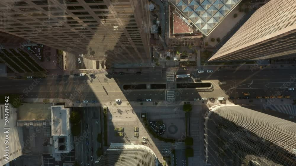 AERIAL: Slow uplifting birds eye View flight over Downtown Los Angeles California Grand Avenue in beautiful Sunrise Light with view of skyscraper rooftops and car traffic passing AERIAL: Slow uplifting birds eye View flight over Downtown Los Angeles California Grand Avenue in beautiful Sunrise Light with view of skyscraper rooftops and car traffic passing