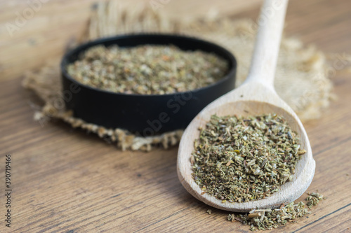 Canvas Print Dry, finely ground cistus leaves, herbal tea on wooden spoon