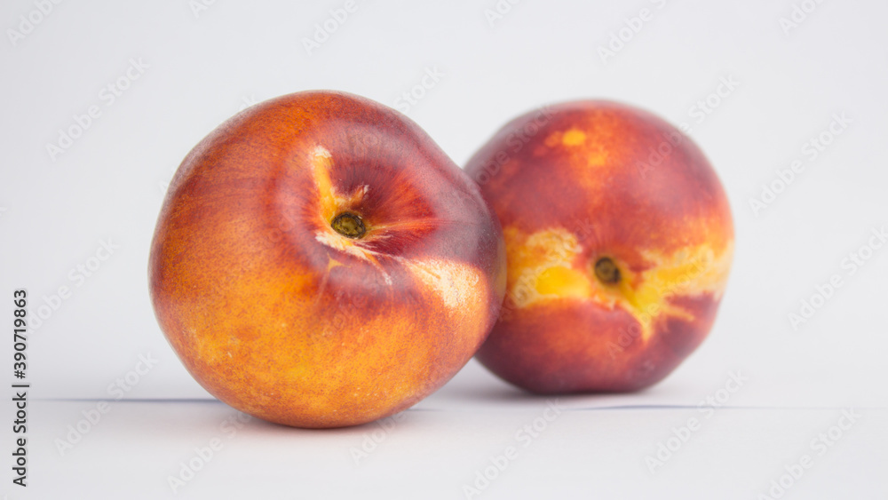 Fresh juicy peaches on a white plate. Close-up Fresh organic peaches nectarine on a white plate. Fresh juicy peaches on a white plate. Close-up Fresh organic peaches nectarine on a white plate.