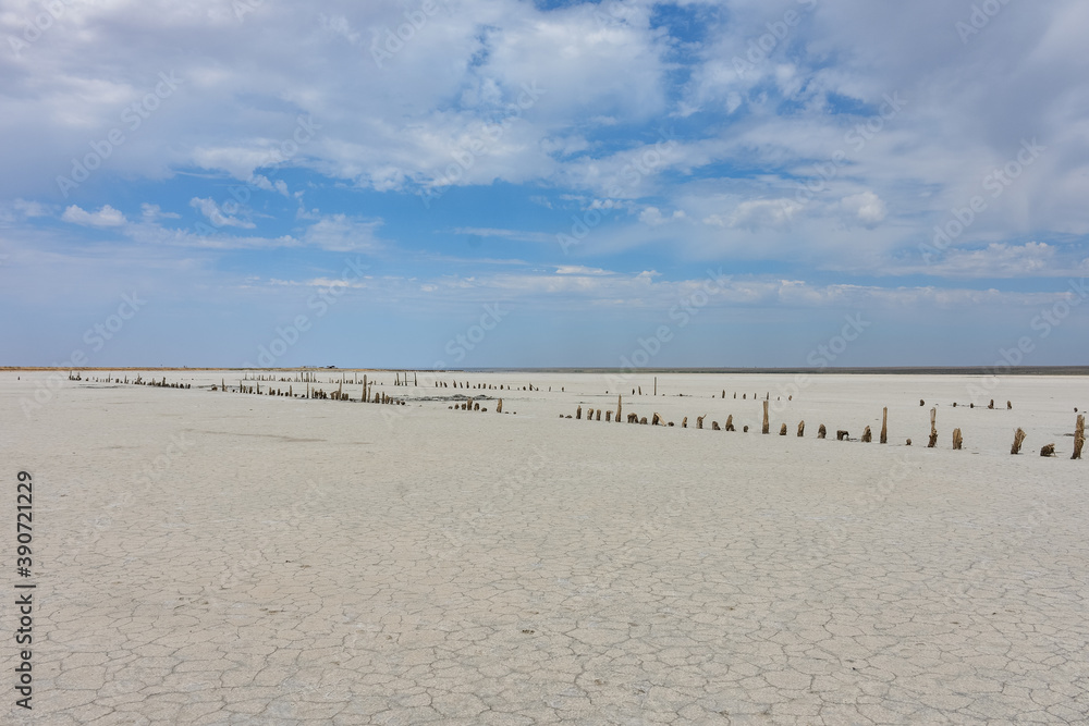 Landscape of a deserted salt lake. The texture of salt formations in the foreground. salt lake surface, dry salt lake, white salt lake Landscape of a deserted salt lake. The texture of salt formations in the foreground. salt lake surface, dry salt lake, white salt lake
