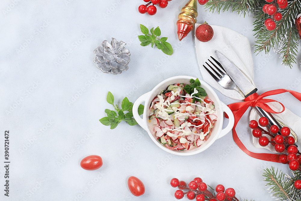 Christmas new year dishes, detox diet concept, traditional festive vegetable salad of cucumber, tomato and radish, healthy lifestyle and wholesome food concept, selective focus