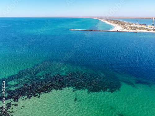 Aerial drone view of a tropical sandy beach dividing an exotic turquoise sea and lake. sand bar in the sea from above, flight over sand bar and colorful sea