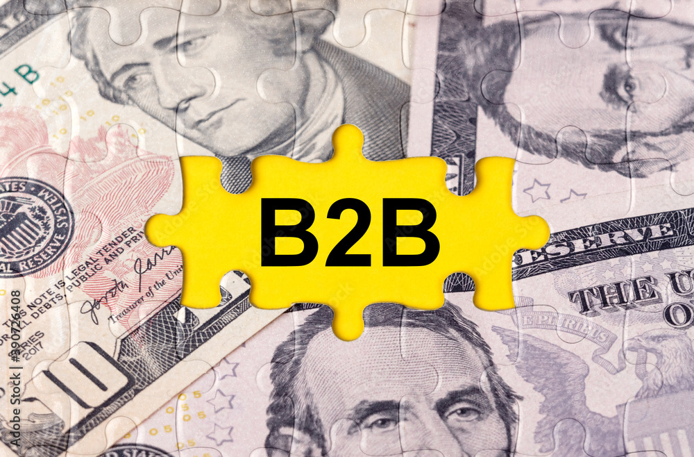 Fototapeta premium Puzzle with the image of dollars in the center of the inscription -B2B