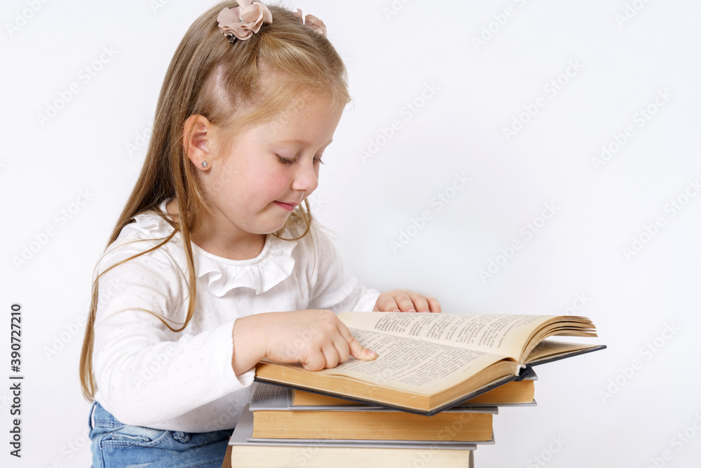Portrait of a teenage girl who sits near books and reads. Isolated over white background. Portrait of a teenage girl who sits near books and reads. Isolated over white background.