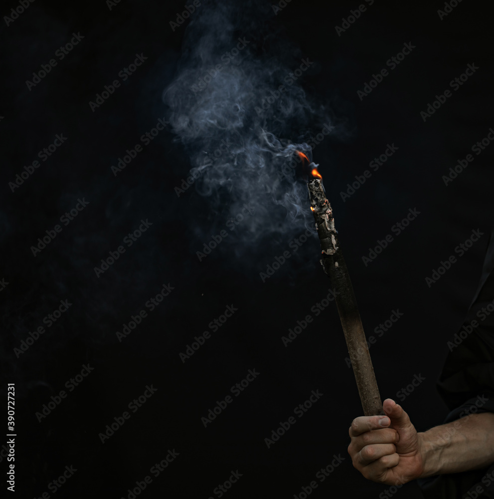 Man hand smoke. Dark background.
Man hand smoke. Dark background.