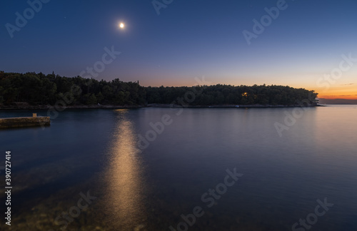 Stone pier on beach Vela Luka in long exposure. Croatia, Brac island, Supetar at night. August 2020