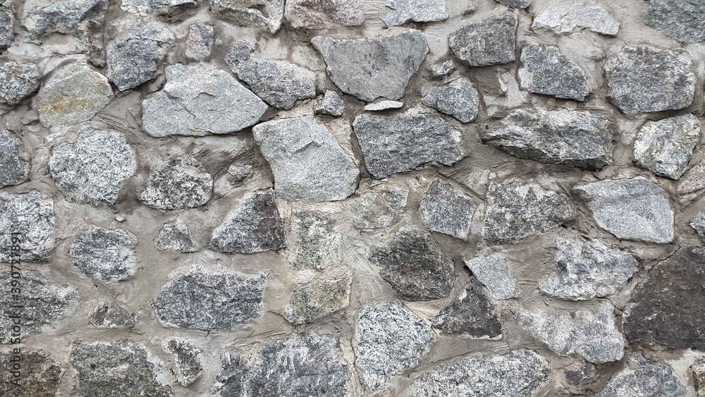 Granite masonry. Wall of granite stones. Vintage background