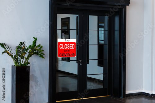 Business center closed due to COVID-19  sign with sorry in door window. Stores  restaurants  offices  other public places temporarily closed during coronavirus pandemic. Economy hit by corona virus
