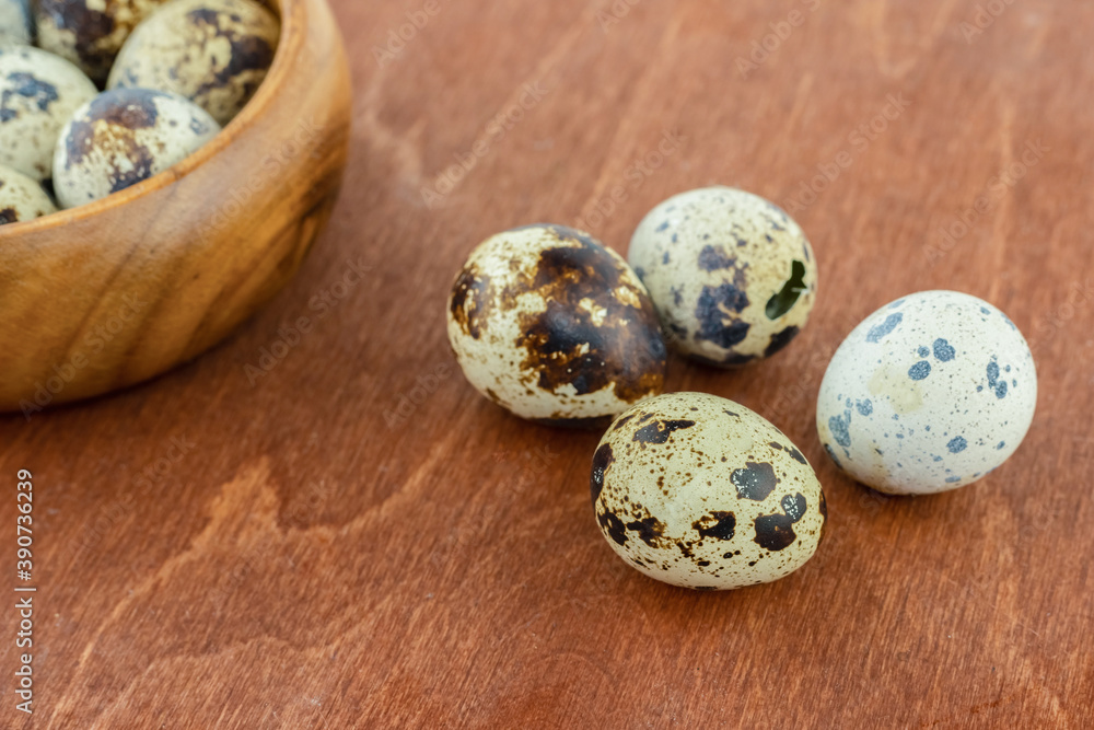 four quail eggs lies on a blackboard against the background of a bowl of breakfast ingredients four quail eggs lies on a blackboard against the background of a bowl of breakfast ingredients