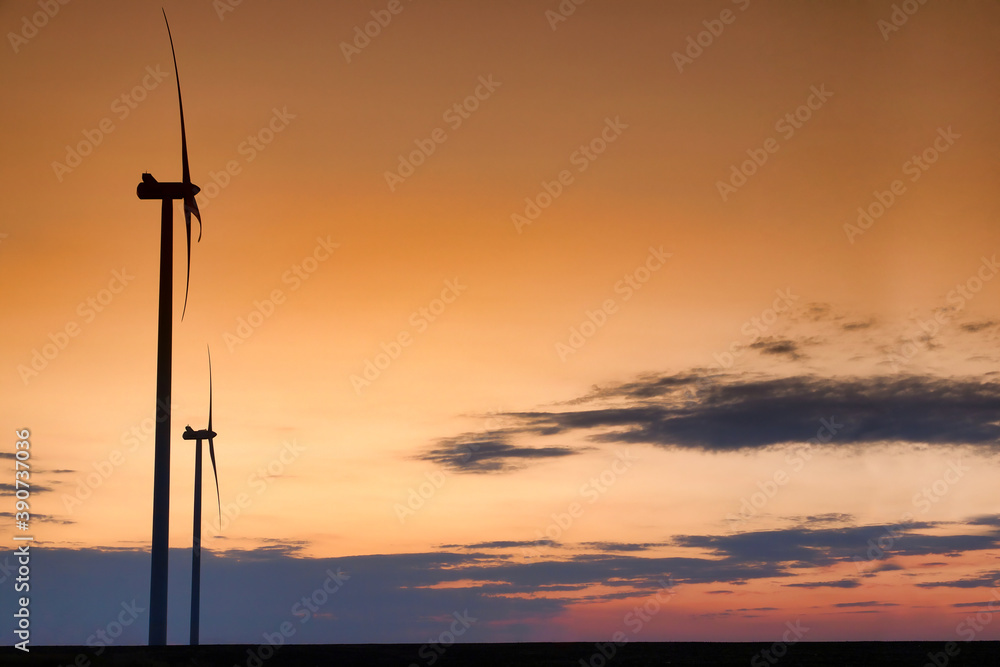 Wind turbine silhouette on beautiful sunset landscape