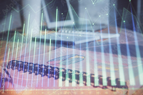 Double exposure of financial graph drawings and desk with open notebook background. Concept of forex market