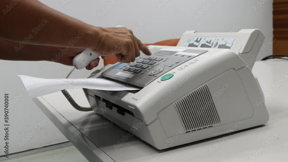 hand man are using a fax machine in the office, equipment for data transmission. hand man are using a fax machine in the office, equipment for data transmission.