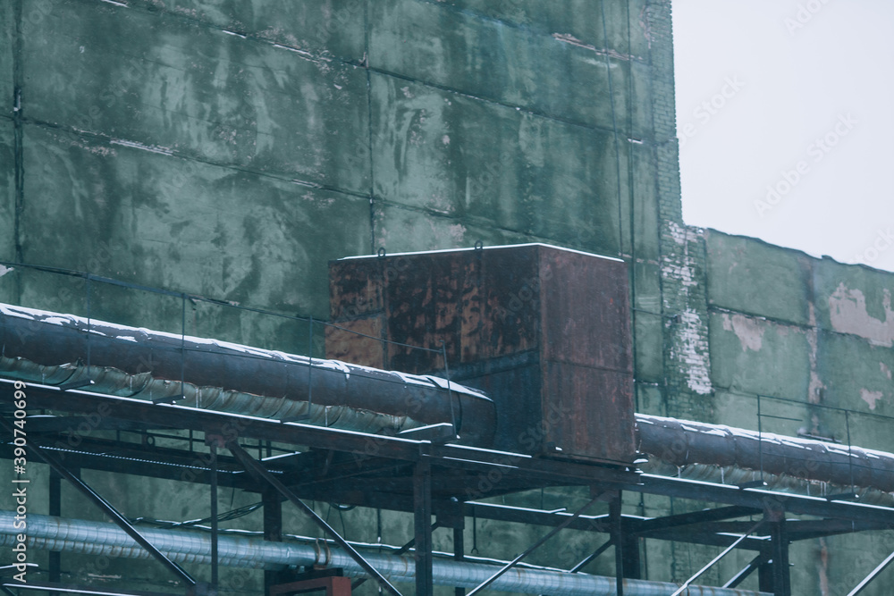 Industrial background, old factory, metal structures, pipes and concrete wall Industrial background, old factory, metal structures, pipes and concrete wall