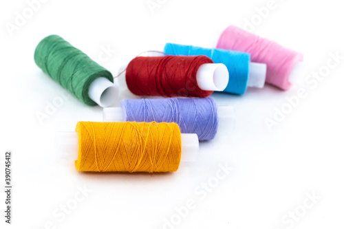 assortment of cotton skeins of orange, red and green material for needlework