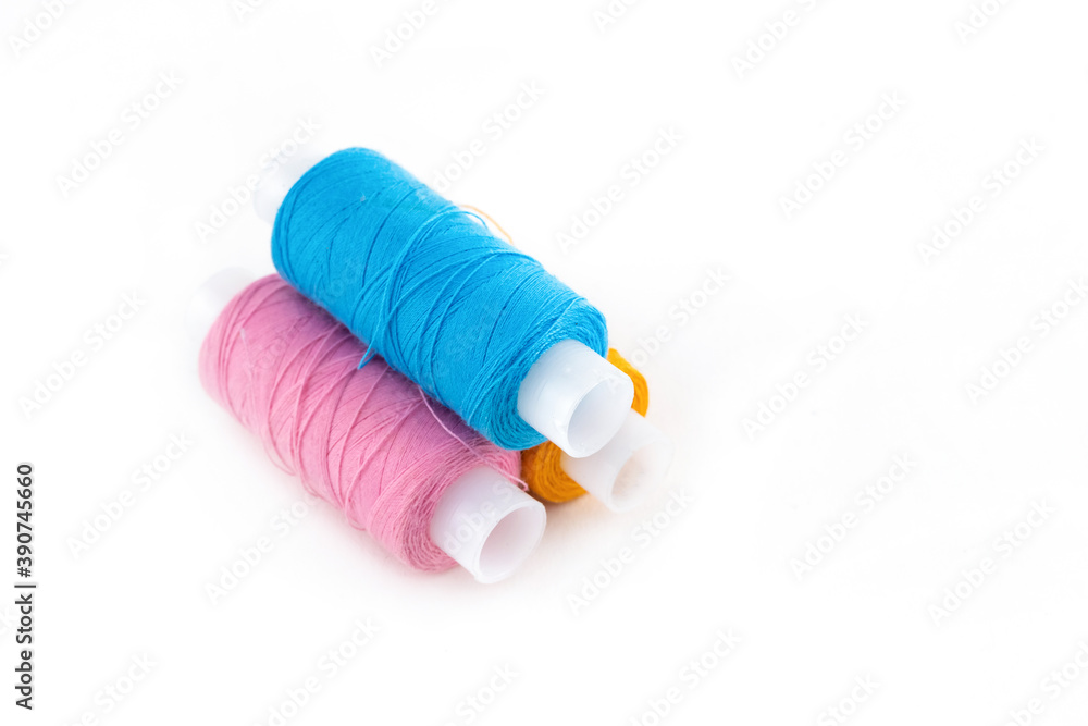 blue and pink skein of thread for needlework on a white and isolated background blue and pink skein of thread for needlework on a white and isolated background