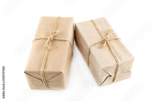 two festive giftbox packed in craft paper on an isolated background