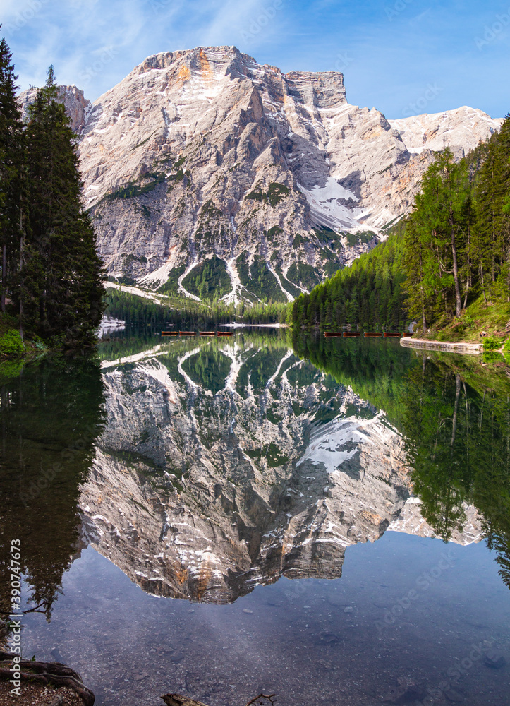 view of Mount Seekofel mirroring in the clear calm water of iconic mountain lake Pragser Wildsee (Lago di Braies) in Dolomites, Unesco World Heritage, South Tyrol, Italy