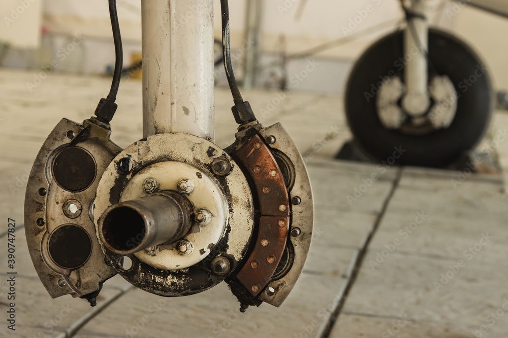 Landing gear of a small private plane standing in the hangar