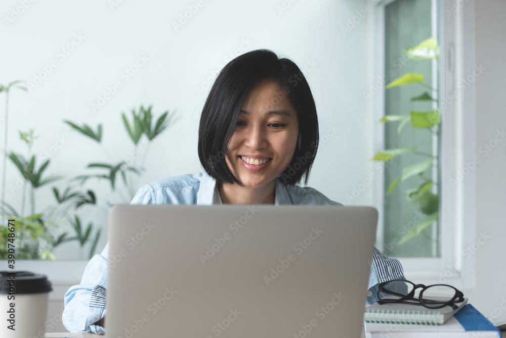 Young asian business woman working on laptop computer in modern office Young asian business woman working on laptop computer in modern office
