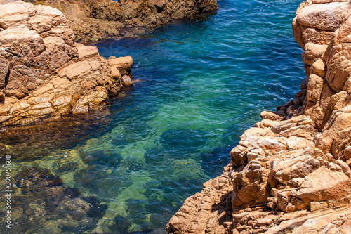 Ocean crystal water between rocks