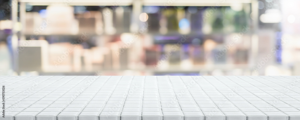 Empty white ceramic mosaic table top and blurred bokeh cafe and restaurant background with vintage filter - can used for display or montage your products.